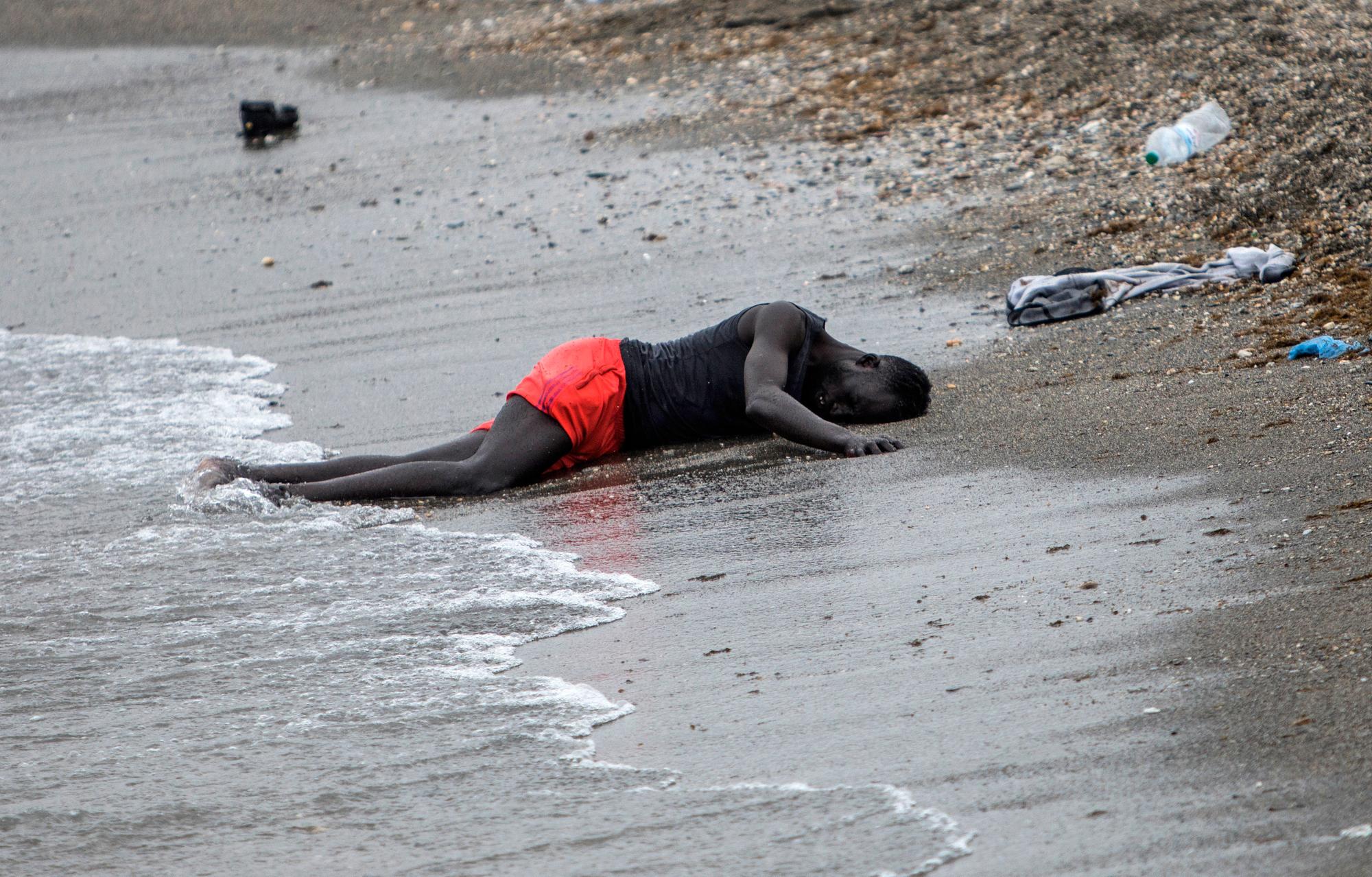 A man lies on the beach in the Spanish enclave of Ceuta in northern Africa after swimming there from Morocco on May 18, 2021. (AP Photo/Javier Fergo)