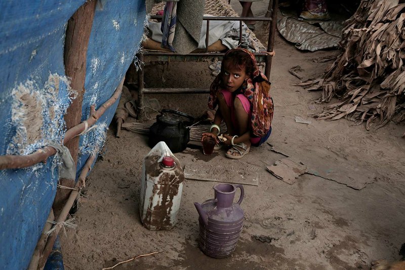 In this Feb. 15, 2018 photo, Awsaf, a thin 5-year-old who is getting no more than 800 calories a day from bread and tea, half the normal amount for a girl her age, drinks tea, in Abyan, Yemen. Hagar Yahia, a mother of eight breaks down in tears talking about her family's deprivation. Late last year, as fighting closed in on Hayis, they fled more than 200 miles, eventually ending up in the village of Red Star on the Arabian Sea coast in the south. Ever since, they've struggled to find enough food. (AP Photo/Nariman El-Mofty)