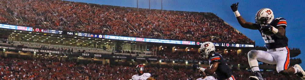 Auburn running back Kerryon Johnson, top right, hurdles Arkansas State defensive back Cody Brown as he runs for a touchdown during the first half of an NCAA college football game, Saturday, Sept. 10, 2016, in Auburn, Ala. (AP Photo/Butch Dill)