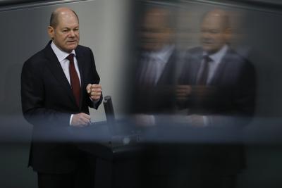 File - In this Tuesday, Dec. 8, 2020 file photo, German Finance Minister Olaf Scholz delivers his speech during the debate about Germany's budget 2021, at the parliament Bundestag in Berlin, Germany. The center-left Social Democrats’ candidate to succeed German Chancellor Angela Merkel is backing the idea of a European Union army. But Olaf Scholz told weekly Frankfurter Allgemeine Sonntagszeitung that likely won’t happen in the near term. (AP Photo/Markus Schreiber, file)