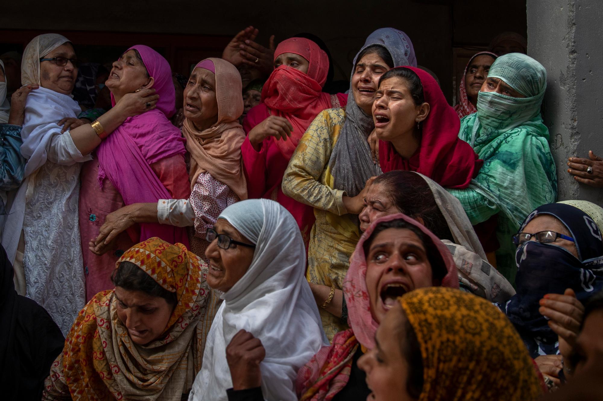 Relatives and neighbors wail during the funeral of Waseem Ahmed, a policeman who was killed in a shootout, on the outskirts of Srinagar, Indian controlled Kashmir, on June 13, 2021. (AP Photo/Dar Yasin)