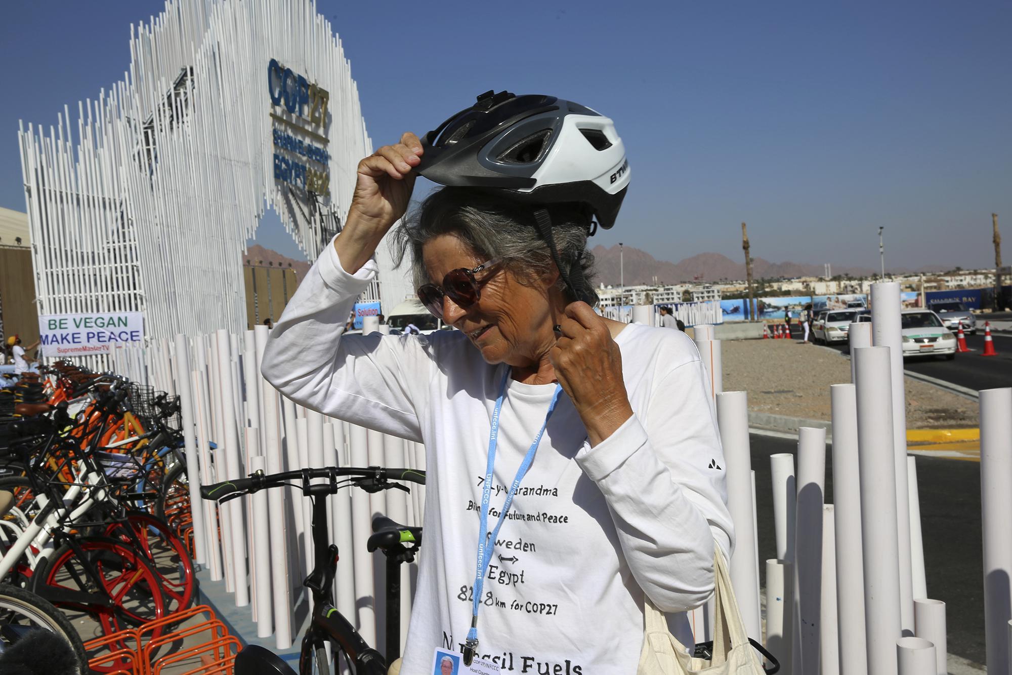 FILE - Dorothee Hildebrandt removes her bike helmet after arriving to the U.N. climate summit COP27 venue in Sharm el-Sheikh, Egypt, Nov. 12, 2022. Hildebrandt found the inspiration to focus her lifelong activism toward the climate change effort because of the younger generation. (AP Photo/Thomas Hartwell, File)