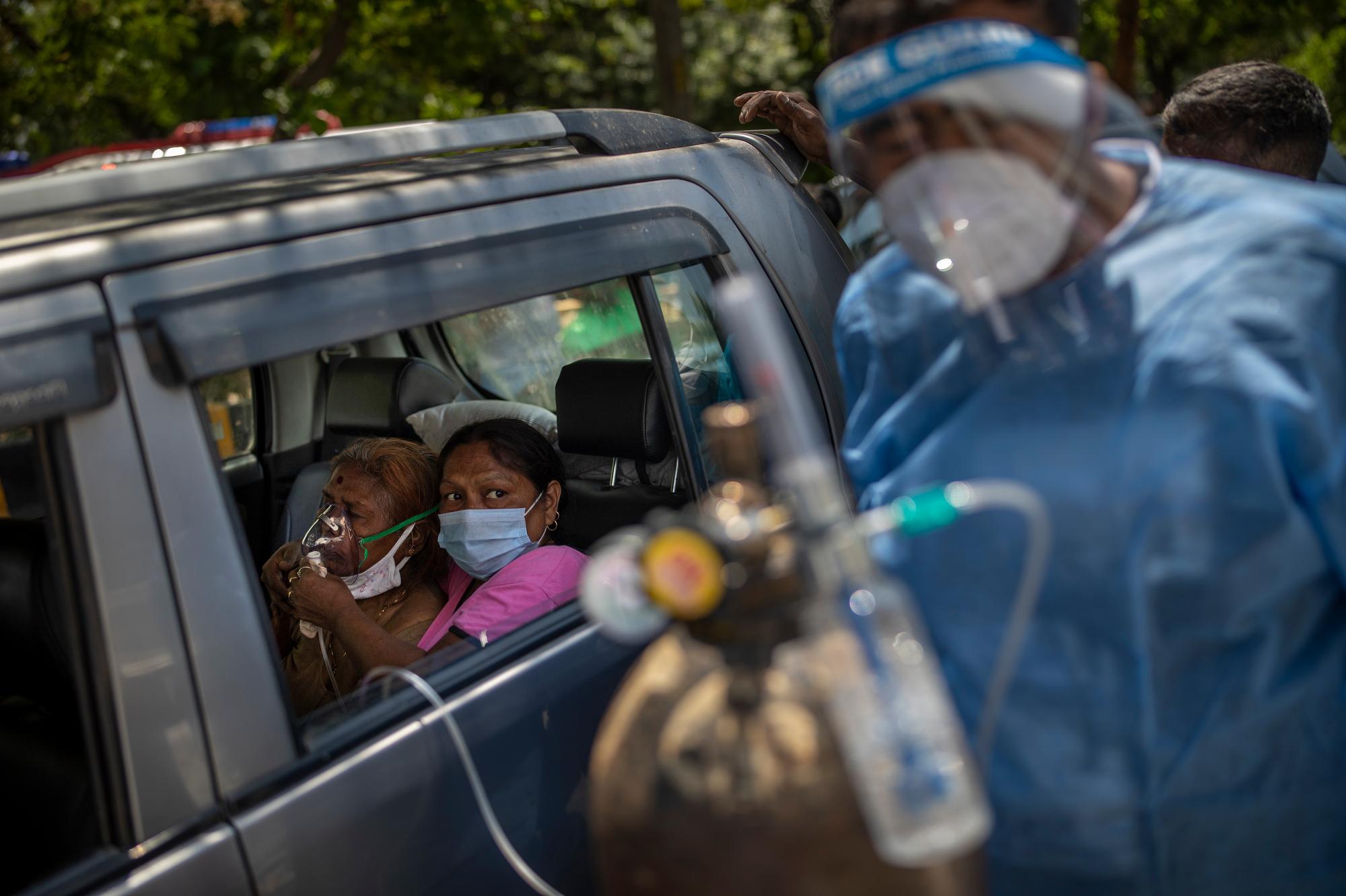 A patient in a car receives oxygen provided by a Gurdwara, a Sikh place of worship, in New Delhi, India, on April 24, 2021. India’s health system has been overwhelmed by the coronavirus pandemic, leaving patients desperate for oxygen and other supplies. (AP Photo/Altaf Qadri)