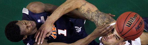 Gonzaga's Robert Sacre, center, is fouled by Illinois' D.J. Richardson (1) while reaching for the loose ball in the second half of an NCAA college basketball game, Saturday, Dec. 4, 2010, in Seattle. No. 20 Illinois won 73-61. (AP Photo/Elaine Thompson)