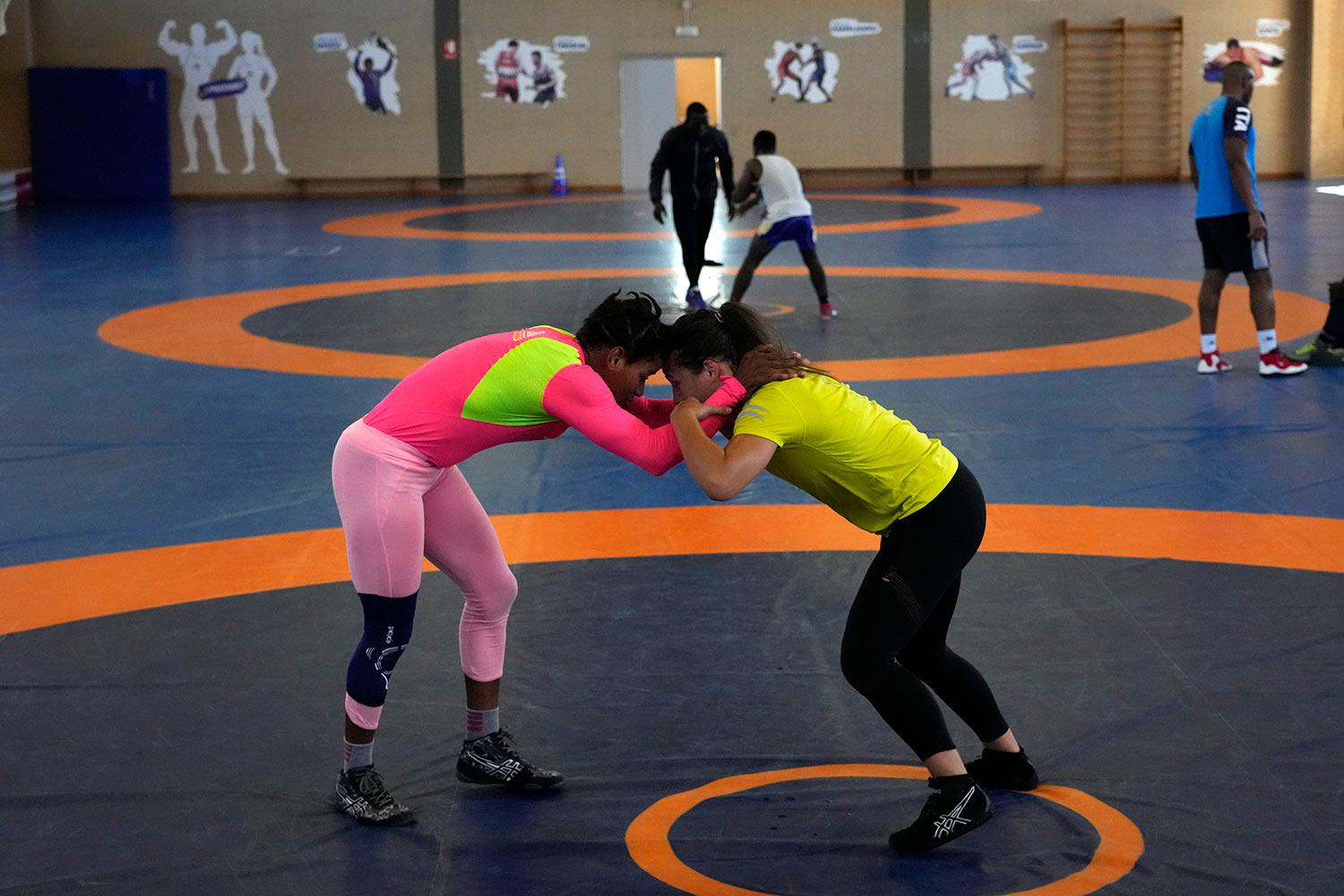 Guinean wrestler Fatoumata Yarie Camara, left competes with Italian athlete Morena De Vita  during her morning training session at the Ostia’s Olympic training center, near Rome, Monday, July 5, 2021. (AP Photo/Alessandra Tarantino)