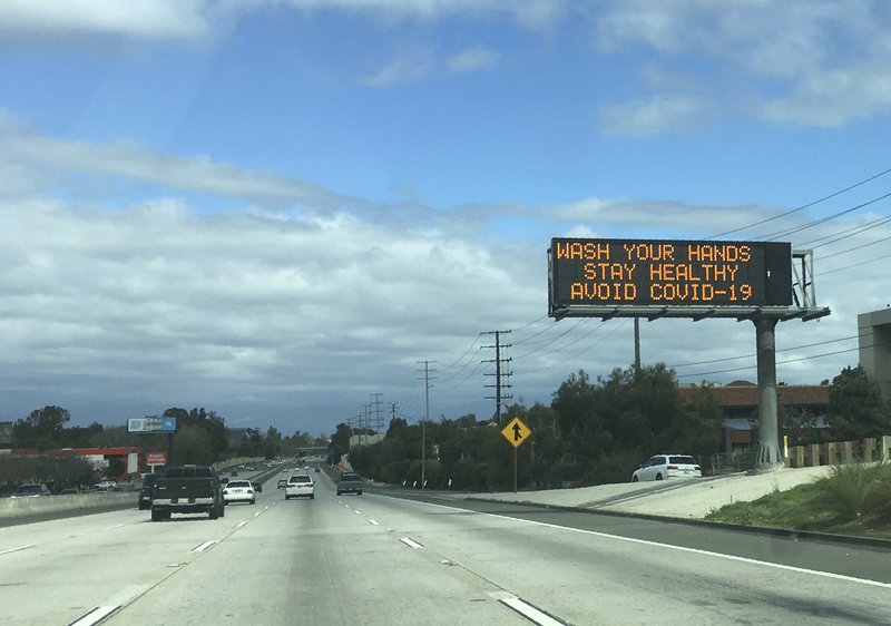 A Caltrans freeway sign reads: "Wash your hands, Stay healthy, Avoid COVID-19" in the San Fernando Valley section of Los Angeles. (AP Photo/John Antczak)