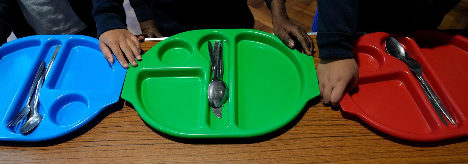 Pupils queue up for lunch in the main hall at the Holy Family Catholic Primary School in Greenwich, London, Wednesday, May 19, 2021. (AP Photo/Alastair Grant)
