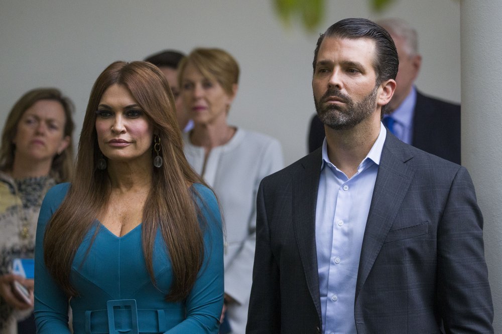 FILE- - In this July 11, 2019, file photo, Donald Trump Jr., the son of President Donald Trump, right, and his girlfriend Kimberly Guilfoyle, listen as President Donald Trump speaks about the 2020 census in the Rose Garden of the White House in Washington. (AP Photo/Alex Brandon, File)