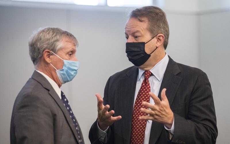 Juul attorney Andrew McGann, right, and Andy Penry, left, an attorney for the state, converse before a hearing regarding the state's case against the e-cigarette company at the Durham County Courthouse in downtown Durham, N.C. on Monday, June 28, 2021. Juul Labs Inc. will pay $40 million to North Carolina and take more action to prevent underage use and sales, according to a landmark legal settlement announced Monday, June 18, 2021, after years of accusations that the company had fueled an explosion in teen vaping. (Julia Wall/The News & Observer via AP)