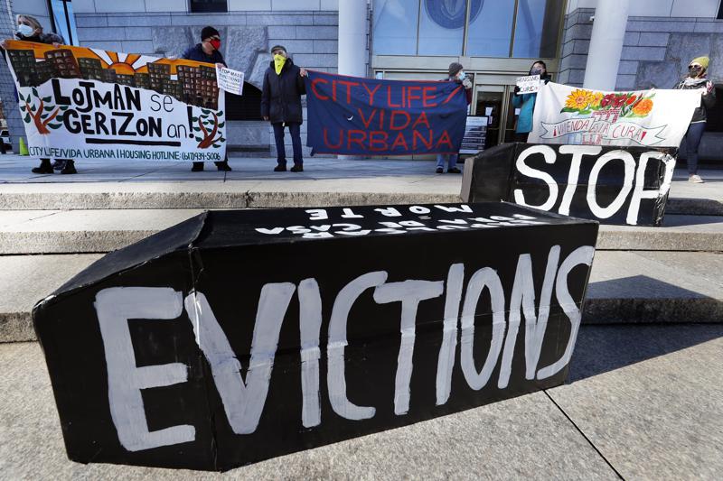 FILE - In this Jan. 13, 2021, file photo, tenants' rights advocates demonstrate in front of the Edward W. Brooke Courthouse in Boston. A federal judge is refusing landlords' request to put the Biden administration’s new eviction moratorium on hold, though she made clear she thinks it's illegal. U.S. District Judge Dabney Friedrich on Friday, Aug. 13, said her “hands are tied” by an appellate ruling the last time courts considered the evictions moratorium in the spring. (AP Photo/Michael Dwyer, File)