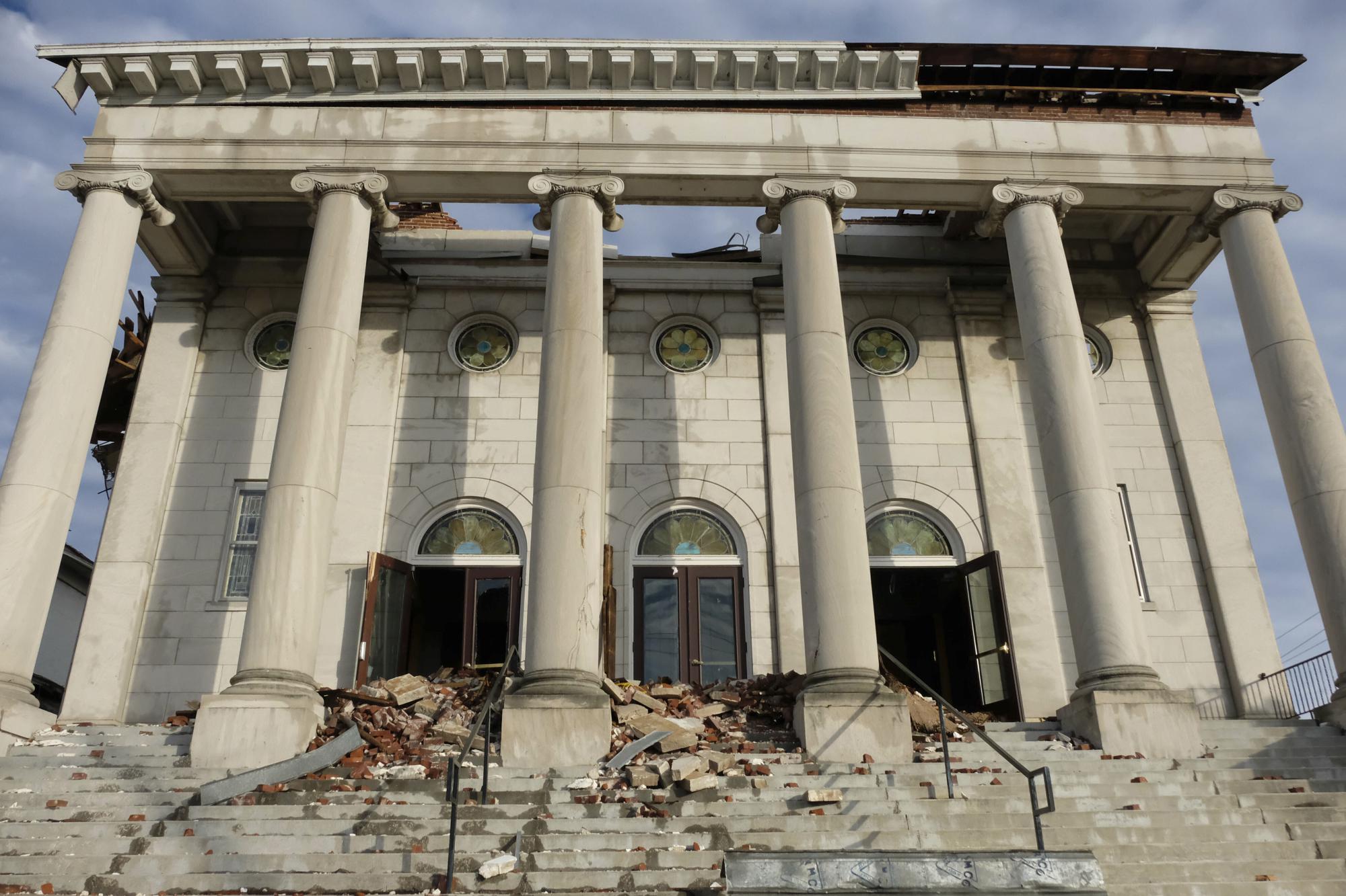 FILE - The damaged facade of the First United Methodist Church is seen on Jan. 9, 2022, in Mayfield, Ky., after the deadly tornado ravaged the city on Dec. 10, 2021. The century-old church has long been an anchor in the Kentucky town of about 10,000 residents, holding countless worship services, weddings, funerals and baptisms. The church members will be celebrating Easter Sunday at their temporary home, Christ United Methodist Church. (AP Photo/Audrey Jackson, File)