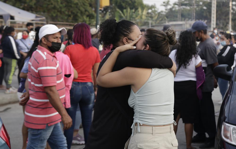 Women hug while waiting for some information about their relatives who are inmates at Litoral Penitentiary, after a prison riot, in Guayaquil, Ecuador, Wednesday, September 29, 2021. The authorities report at least 100 dead and 52 injured in the riot on Tuesday at the prison. (AP Photo/Angel DeJesus)