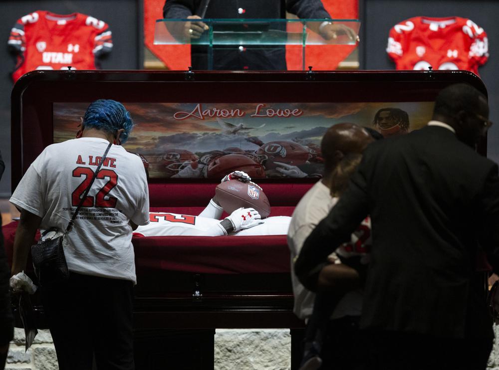 Friends and family pay their respects to Aaron Lowe during a funeral service at Family Cathedral of Praise, Monday, Oct. 11, 2021, in Mesquite, Texas. Lowe, a student and football player at the University of Utah, was was shot and killed on Sept. 26 at a post-game party. (AP Photo/Brandon Wade)