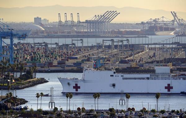 FILE - The USNS Mercy enters the Port of Los Angeles, March 27, 2020, in Los Angeles. A train engineer who intentionally derailed a locomotive near the U.S. Navy hospital ship that was deployed in Los Angeles harbor to help during the COVID-19 pandemic was sentenced, Wednesday, April 13, 2022, to three years in prison. (AP Photo/Mark J. Terrill, File)