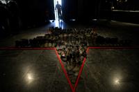 Russian boots are displayed at the "Ukraine Crucifixion" exhibition in Kyiv, Ukraine, Sunday, June 12, 2022. Objects discarded by the Russian military are displayed in World War II museum known as the Museum of the Great Patriotic War in Ukraine as part of an exhibition focusing on the devastation of ongoing war. (AP Photo/Natacha Pisarenko)