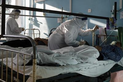 Médicos con trajes de protección contra el coronavirus atienden a pacientes con coronavirus en una UCI de un hospital en Volgograd, Rusia, el domingo 21 de noviembre de 2021. (AP Foto/Alexandr Kulikov)