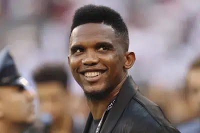 FILE - Soccer player Samuel Eto'o watches warmups before an International Champions Cup soccer match between Atletico Madrid and Real Madrid, Friday, July 26, 2019, in East Rutherford, N.J. Cameroon soccer federation president Samuel Eto'o was filmed apparently kicking a man to the ground in an altercation outside a World Cup stadium early on Tuesday. Eto'o had paused to pose for photos with fans near Stadium 974 after Brazil beat South Korea 4-1. Footage circulating on social media showed him then reacting to comments by a man holding a camera. (AP Photo/Steve Luciano, File)