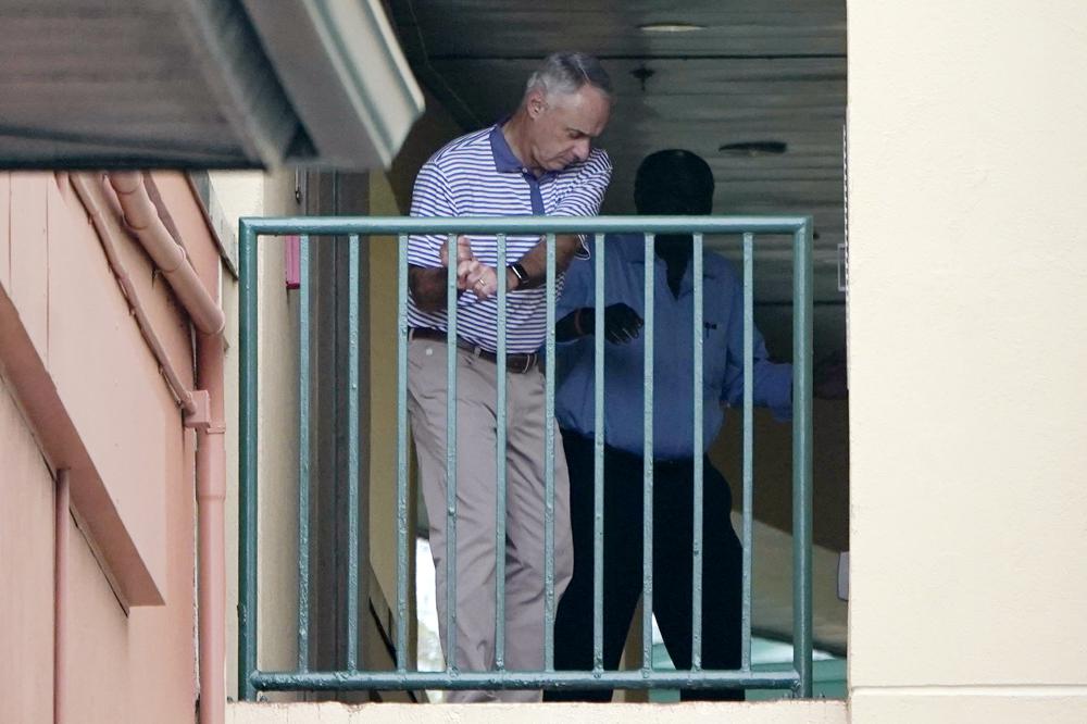 Major League Baseball Commissioner Rob Manfred practices his golf swing as negotiations continue with the players' association toward a labor deal, Tuesday, March 1, 2022, at Roger Dean Stadium in Jupiter, Fla. (AP Photo/Lynne Sladky)