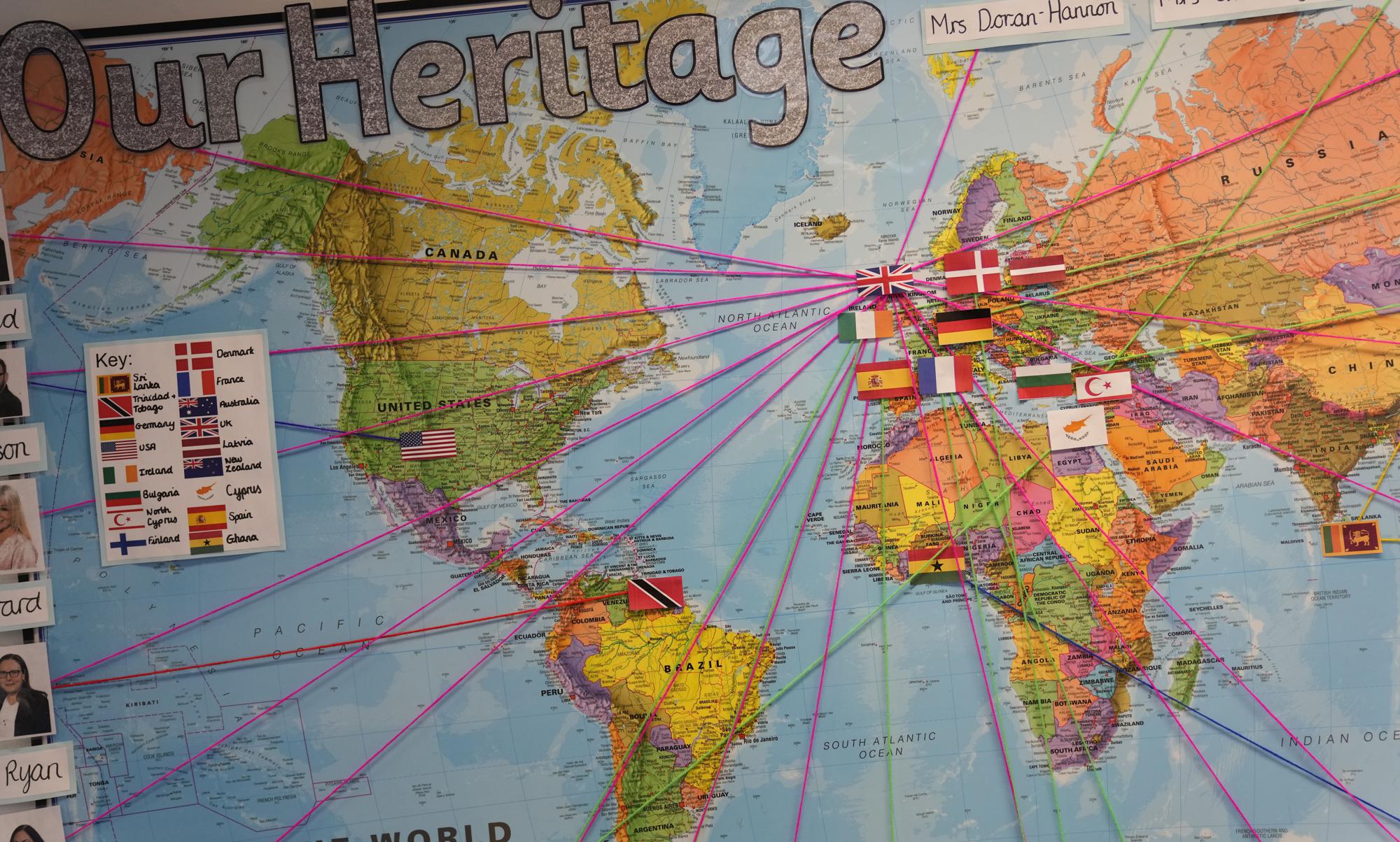 A world map showing the origins of members of staff at the Holy Family Catholic Primary School in Greenwich, London, Wednesday, May 19, 2021. Holy Family, like schools across Britain, is racing to offset the disruption caused by COVID-19, which has hit kids from low-income and ethnic minority families hardest.  (AP Photo/Alastair Grant)