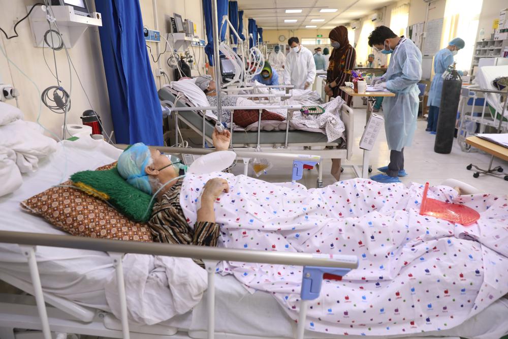 Afghan doctors check a COVID-19 patient files at the Afghan-Japan Communicable Disease Hospital in Kabul, Afghanistan, Sunday, May 30, 2021. Afghanistan is battling a brutal third wave of COVID infections, while health officials plead for vaccines, expressing deep frustration at the inequities of the global vaccine distribution. Positive COVID cases jump from eight percent to 60 per cent in some parts of the country. (AP Photo/Rahmat Gul)