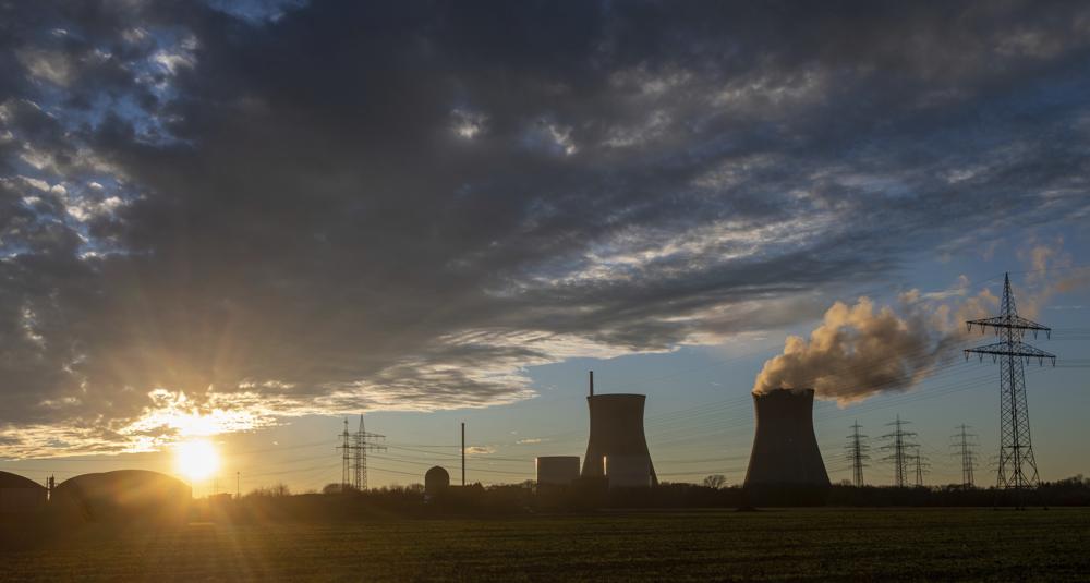 Steam rises from the cooling tower of the nuclear power plant of Gundremmingen, Bavaria, Friday, Dec. 31, 2021. Bavaria's penultimate nuclear reactor will go offline today. (Stefan Puchner/dpa via AP)