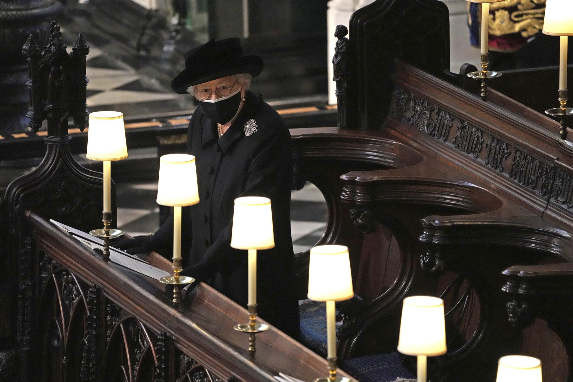 FILE - Britain's Queen Elizabeth II in St. George's Chapel during the funeral of Prince Philip, the man who had been by her side for 73 years, at Windsor Castle, Windsor, England, April 17, 2021. Queen Elizabeth II, Britain’s longest-reigning monarch and a rock of stability across much of a turbulent century, has died. She was 96. Buckingham Palace made the announcement in a statement on Thursday Sept. 8, 2022 (Yui Mok/Pool via AP, File)