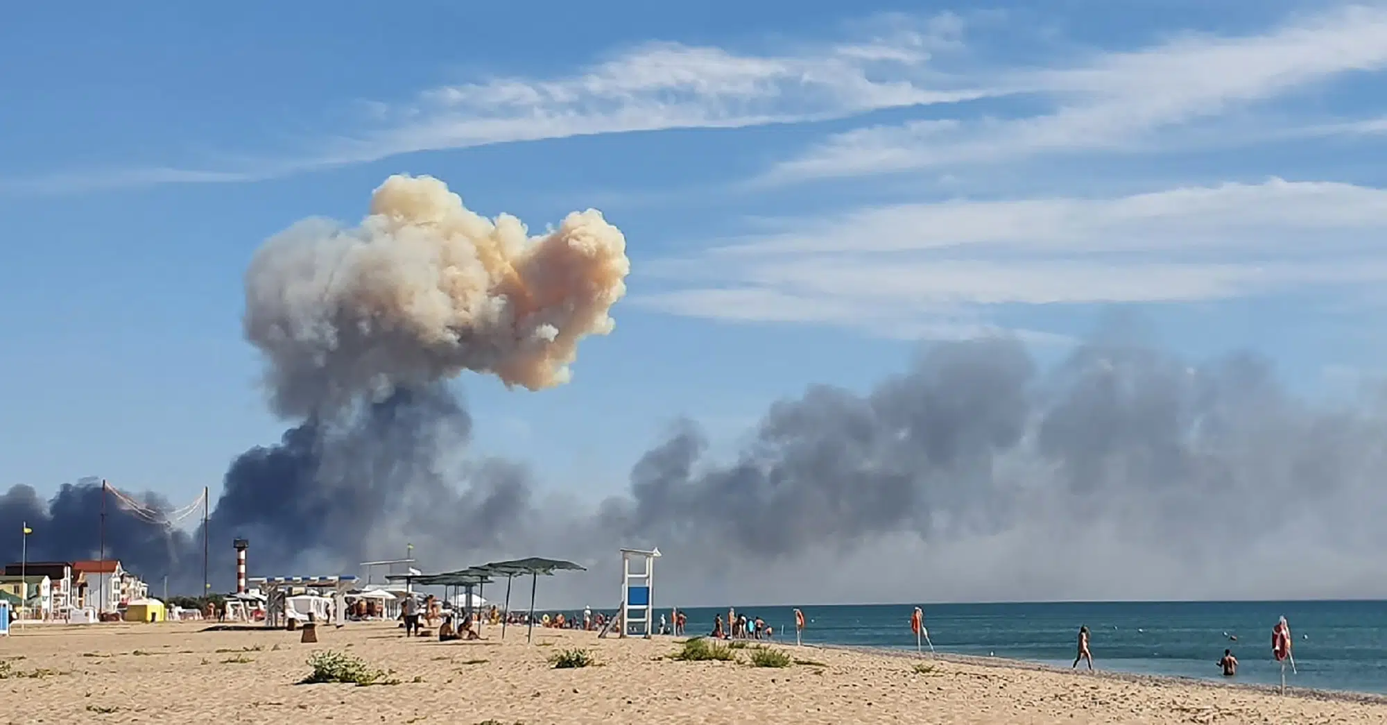 FILE - Rising smoke can be seen from the beach at Saky after explosions were heard from the direction of a Russian military airbase near Novofedorivka, Crimea, Aug. 9, 2022. (UGC via AP, File)