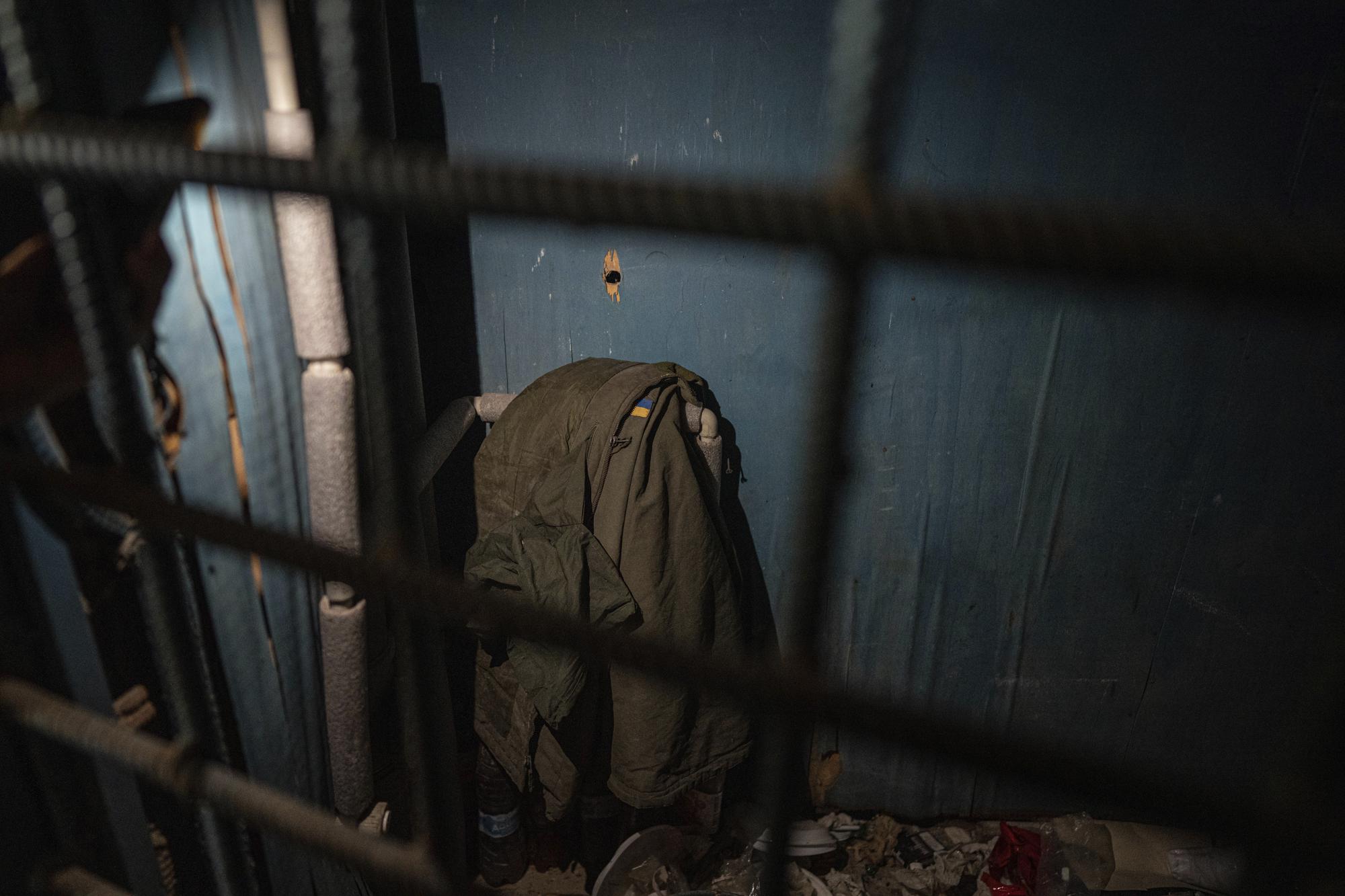 A Ukrainian soldier's jacket with a national flag is sits in a room at School No. 2 in the recently liberated town of Izium, Ukraine, Wednesday, Sept. 21, 2022. The school also served as a base and field hospital for Russian soldiers, and at least two Ukrainian civilians held there died. (AP Photo/Evgeniy Maloletka)