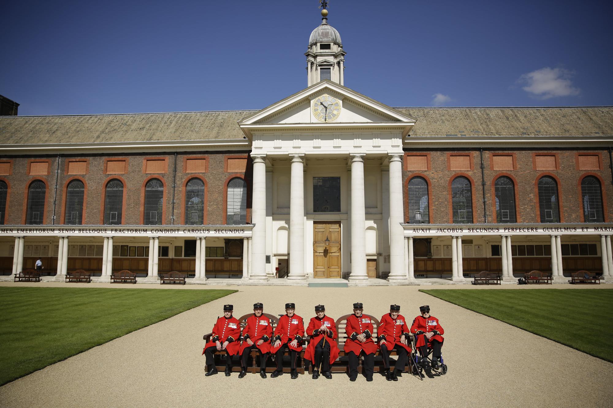 FILE - British Chelsea Pensioners who are veterans of the World War II Battle of Normandy, codenamed Operation Overlord, and D-Day pose for a group photograph during a D-Day 75th anniversary photocall at the Royal Hospital Chelsea in London, Monday, May 13, 2019. The 75th anniversary of D-Day is on 6 June, pictured are from left: Roy Cadman, James George, Bill Fitzgerald, Ernie Boyden, Frank Mouque, George Skipper, Arthur Ellis. D-Day saw some 156,000 U.S., British and Canadian forces landing on five beaches along a 50 mile (80 kilometer) stretch of France's coast, supported by thousands of ships, landing vessels, planes and gliders, and with inland help from French resistance fighters. (AP Photo/Matt Dunham, File)