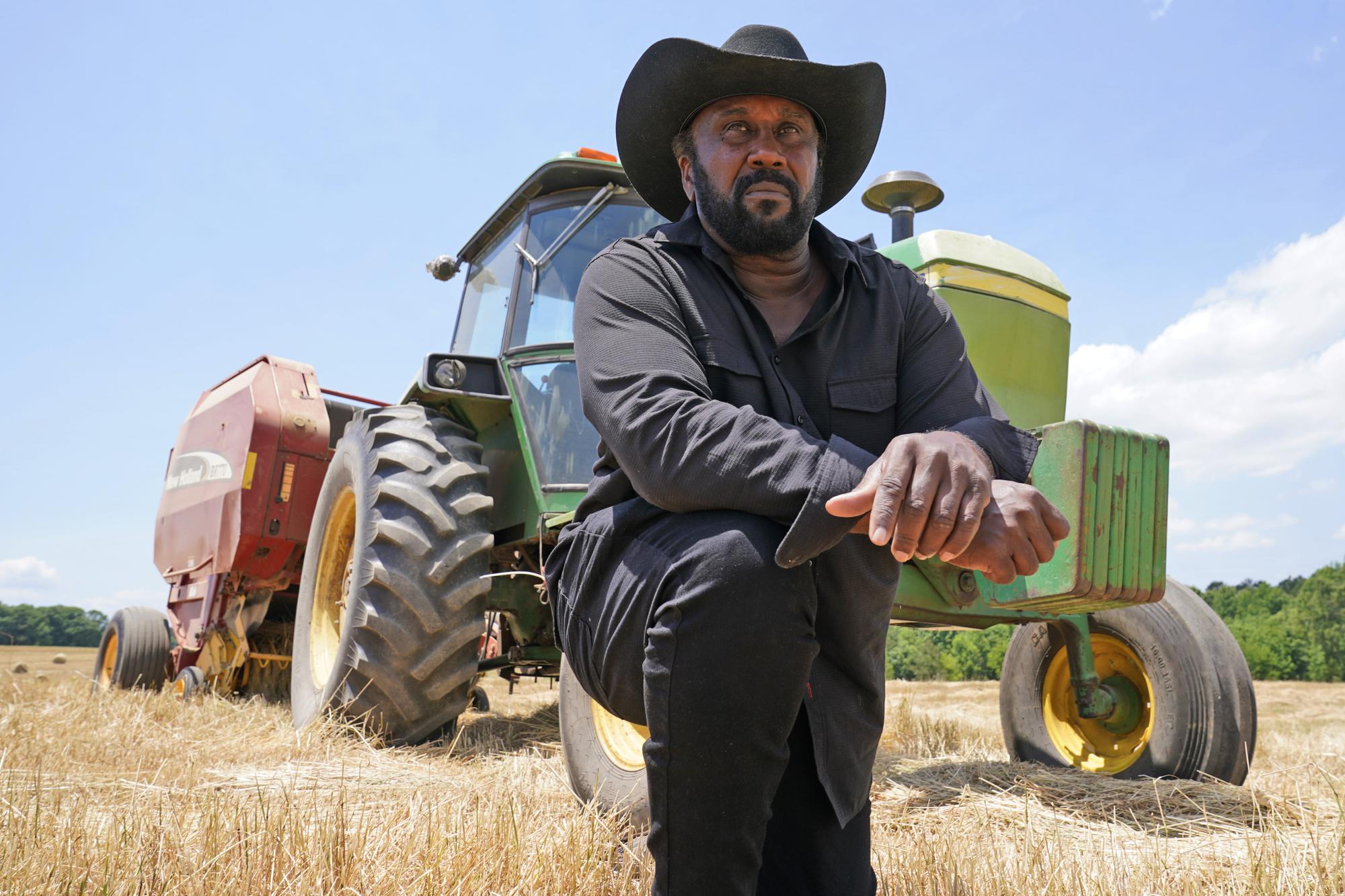 Farmer John Boyd Jr., poses for a portrait during a break from bailing hay at his farm in Boydton, Va., Thursday, May 27, 2021. Documents from a USDA internal review that Boyd provided to The Associated Press show investigators found his operating loan requests were not processed for years, despite explicit instructions from the agency’s state director. (AP Photo/Steve Helber)