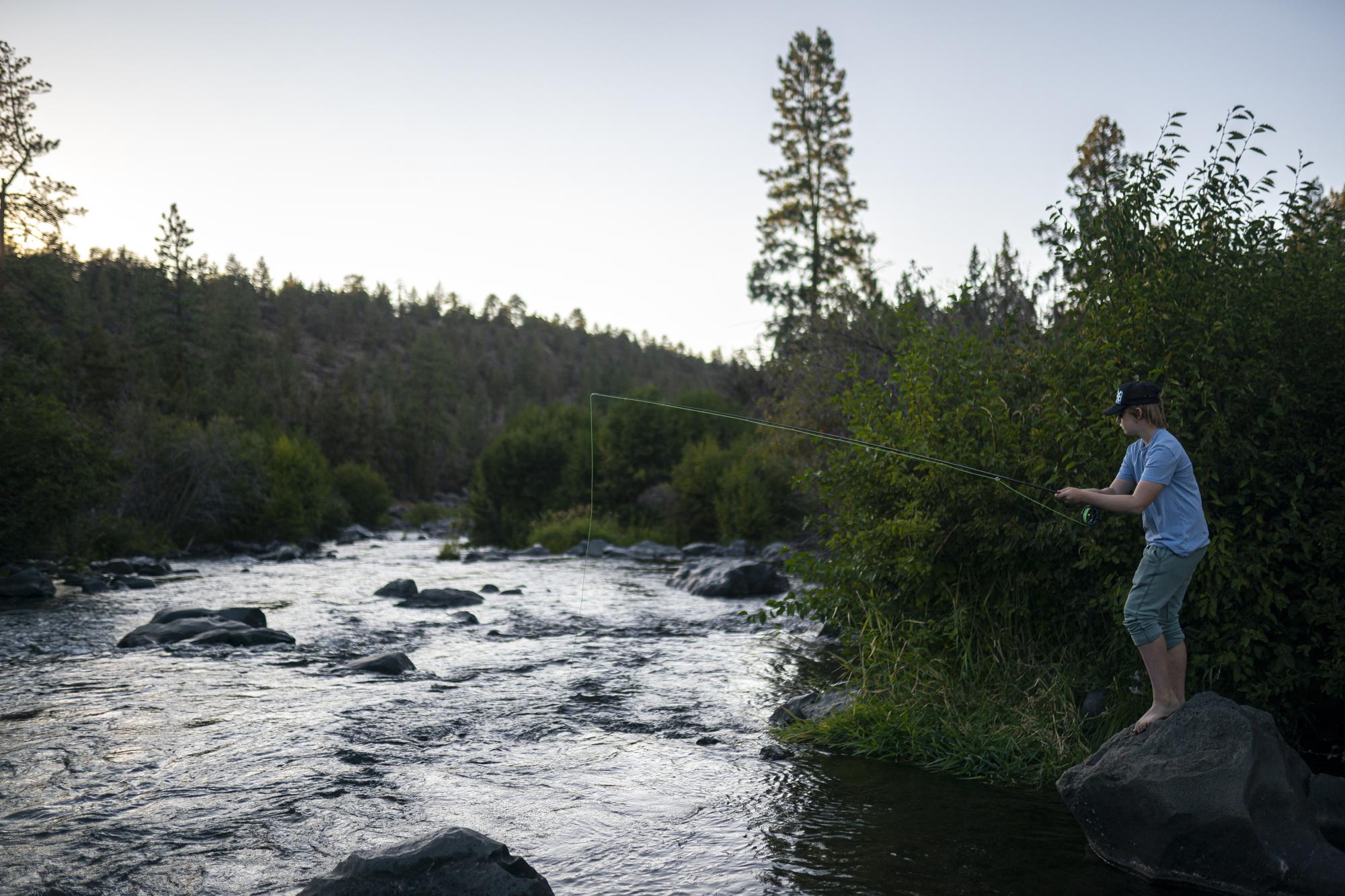 Arbor Bennet fly fishes along Deschutes River on Tuesday, Aug. 31, 2021, in Bend, Ore. In this fertile swath of central Oregon, where six irrigation districts rely on the river, the consequences of the strict hierarchy dictated by the American West’s arcane water law — 