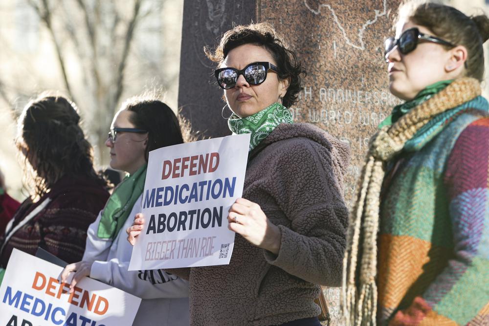 Lindsay London holds protest sign in front of federal court building in support of access to abortion medication outside the Federal Courthouse on Wednesday, March 15, 2023 in Amarillo, Texas. A conservative federal judge heard arguments Wednesday from a Christian group seeking to overturn the Food and Drug Administration’s more than 2-decade-old approval of an abortion medication, in a case that could threaten the most common form of abortion in the U.S. (AP Photo/David Erickson)