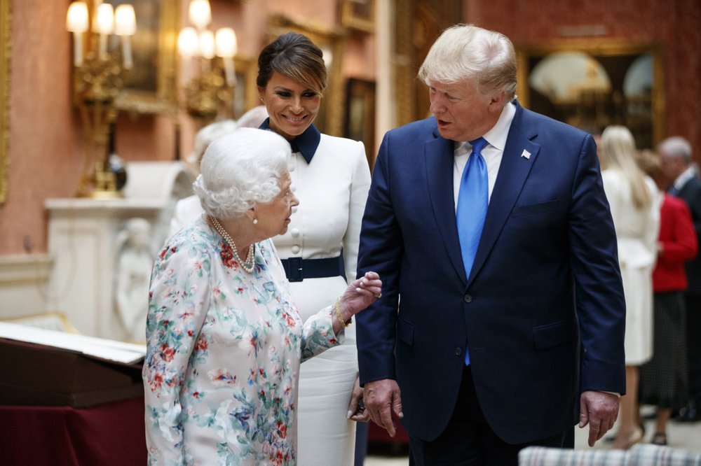 Britain's Queen Elizabeth II speaks to U.S President Donald Trump, right and first lady Melania as they view U.S memorabilia from the Royal Collection, at Buckingham Palace, London, Monday, June 3, 2019. Trump is on a three-day state visit to Britain. (Tolga Akmen/Pool Photo via AP)