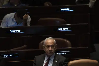 FILE - Israeli Prime Minister designate Benjamin Netanyahu, center, pauses during a session after Yariv Levin was selected as Speaker of the Knesset, Israel's parliament, in Jerusalem, Tuesday, Dec. 13, 2022. Over 1,000 senior Israeli air force veterans, including a former Israeli chief of staff, on Monday, Dec. 26, 2022, urged the country’s top legal officials to stand tough against the incoming government, saying the alliance of religious and ultranationalist parties threatens Israel’s future.(AP Photo/ Maya Alleruzzo, File)