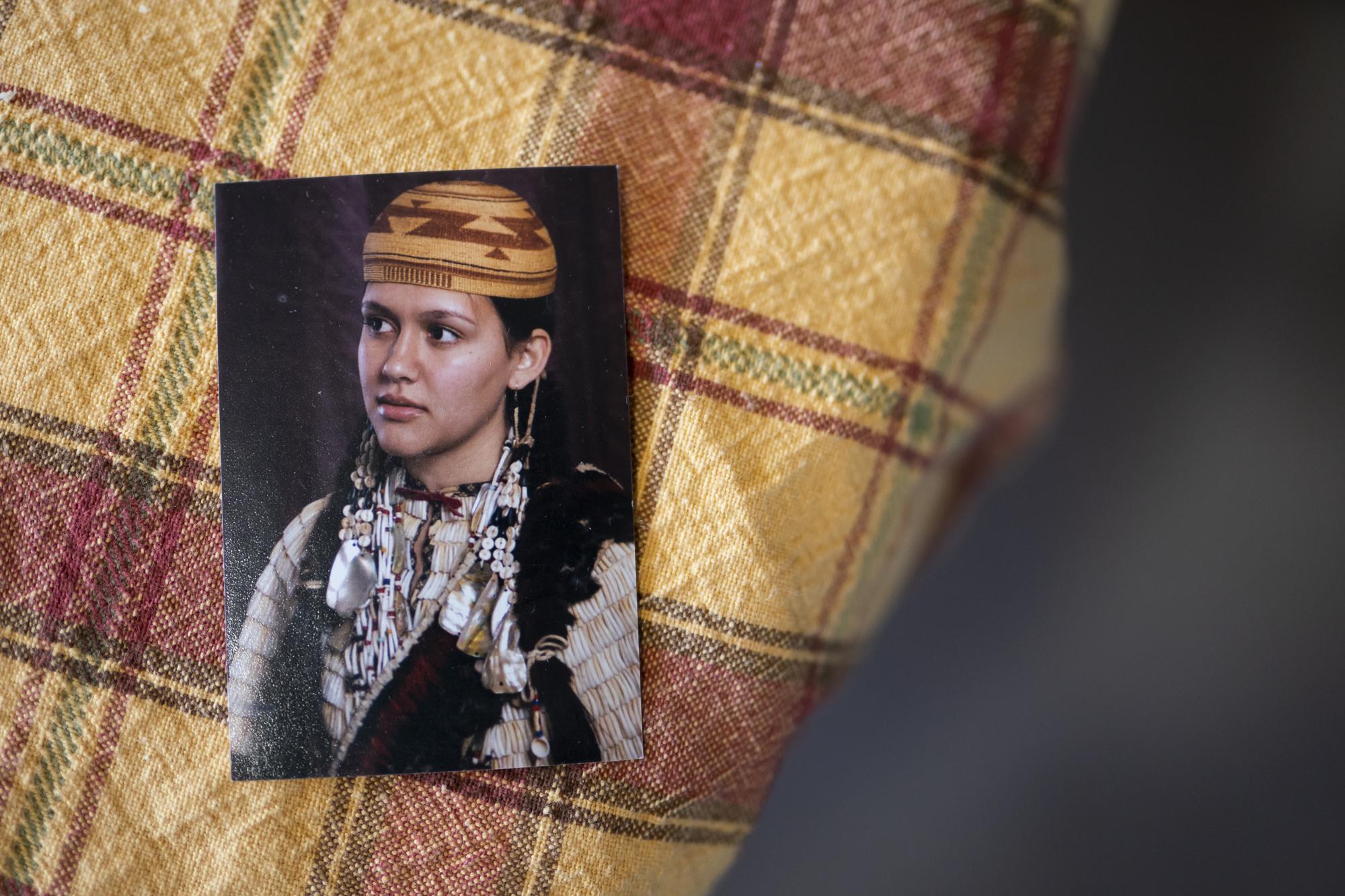 A picture of missing woman Emmilee Risling sits on a table at the Risling family home on Jan. 21, 2022, in McKinleyville, Calif. The 33-year-old college graduate — an accomplished traditional dancer with ancestry from three area tribes — was last seen more than four months ago walking across a bridge near End of Road, a far corner of the Yurok Reservation where the rutted pavement dissolves into thick woods. Her disappearance is one of five instances in the past 18 months where Indigenous women have gone missing or been killed in an isolated expanse of Pacific coastline between San Francisco and Oregon, a region where the Yurok, Hupa, Karuk and Wiyot people have co-existed for millenia. (AP Photo/Nathan Howard)