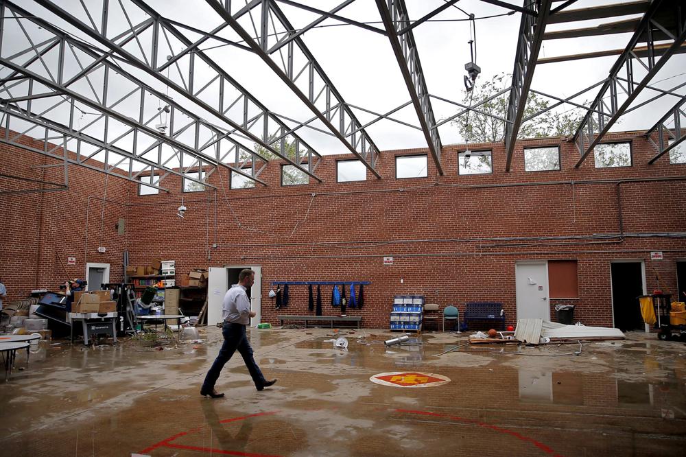 Paul Campbell, Founder of the academy of Seminole, walks through the damage caused by a tornado to the school building in Seminole, Okla. on Thursday, May, 5, 2022. A springtime storm system spawned several tornadoes that whipped through areas of Texas and Oklahoma, causing damage to a school, a marijuana farm and other structures. (Sarah Phipps/The Oklahoman via AP)