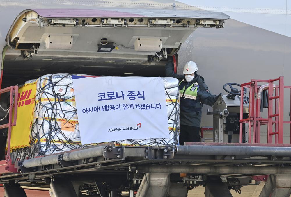 Workers unload a cargo shipment containing the first batches of Pfizer’s antiviral COVID-19 pill, Paxlovid, at a cargo terminal at the Incheon International Airport, west of Seoul, South Korea on Thursday, Jan. 13, 2022. (Jung Yeon-je/Pool photo via AP)