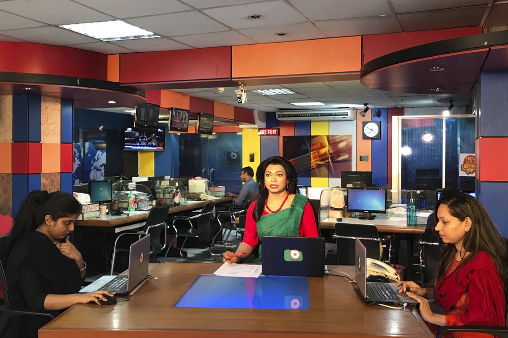 Bangladesh's first transgender news anchor Tashnuva Anan Shishir, center, reads news bulletin , in Dhaka, Bangladesh, Tuesday, March 9, 2021.