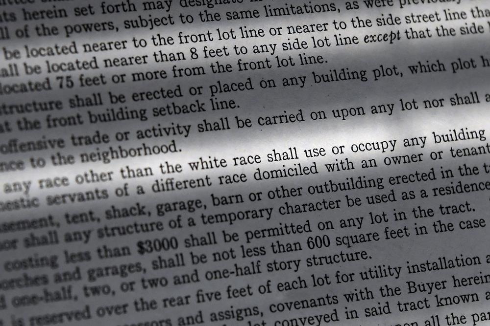 In this Saturday, July 17, 2021, photo, a copy of a covenant for property now owned by Fred Ware is seen in Manchester, Conn. Fred and Dave Ware recently found a whites-only covenant on his property dating back to 1942 when researching the title chain. The covenant described as letter 