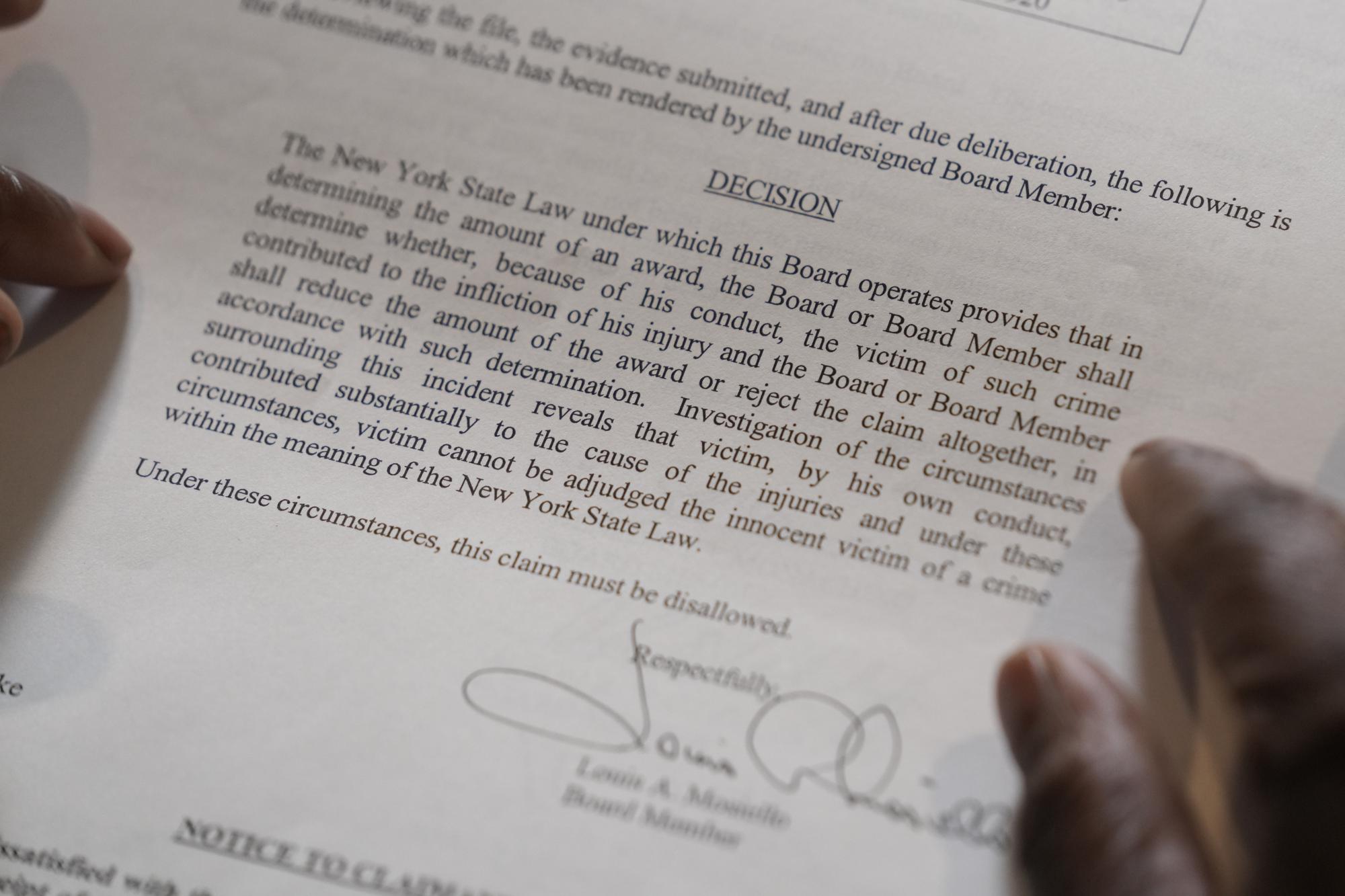 In this April 19, 2023 photo, Debra Long of Poughkeepsie, N.Y., holds the letter that explains why she was initially denied reimbursement for the funeral of her son, Randy Long, who was murdered in 2006. An AP examination of data from 23 states shows that Black people are disproportionately denied aid from programs that reimburse victims of violent crime. (AP Photo/Seth Wenig)