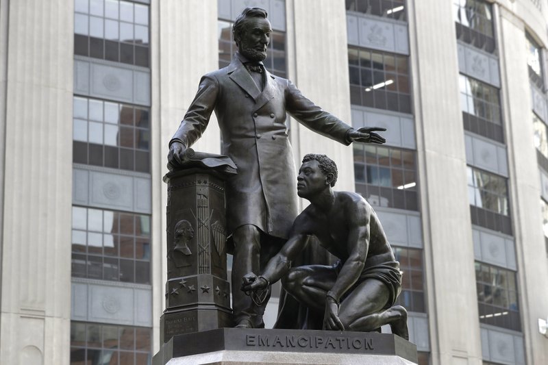 FILE - In this June 25, 2020, file photo, a statue that depicts a freed slave kneeling at President Abraham Lincoln's feet rests on a pedestal in Boston. On Tuesday, Dec. 29, the statue that drew objections amid a national reckoning with racial injustice was removed from its perch. (AP Photo/Steven Senne, File)