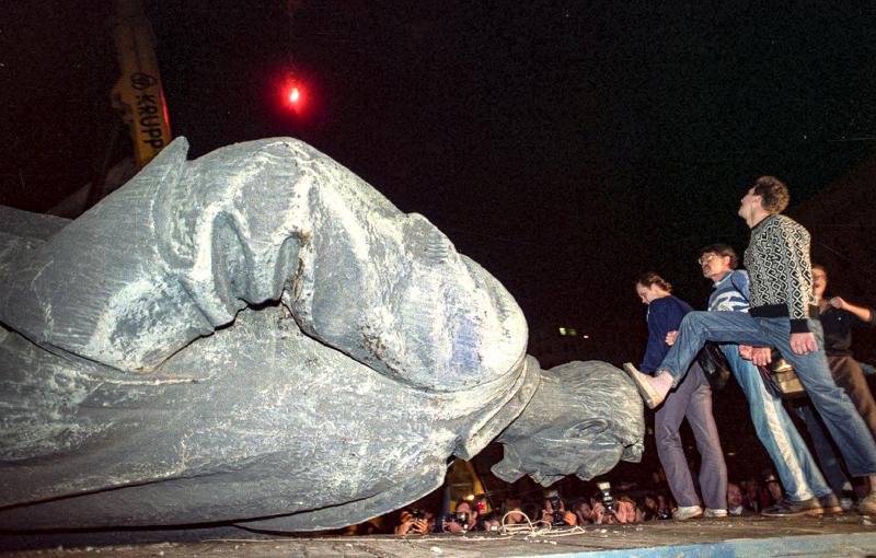 FILE - In this Friday, Aug. 23, 1991 file photo, people kick the head of the statue of Felix Dzerzhinsky, the founder of the Soviet secret police, in front of the KGB main headquarters on the Lubyanka Square in Moscow, Russia. The statue was pulled down after the defeat of the August 1991 hardline coup. I was out on the streets, shooting exultant crowds across the city and managed to catch the moment when demonstrators pulled down the statue of Felix Dzerzhinsky, the founder of the Soviet secret police, in front of the KGB main headquarters on the Lubyanka Square - a watershed moment that symbolized the collapse of the repressive Soviet system.(AP Photo/Alexander Zemlianichenko, File)