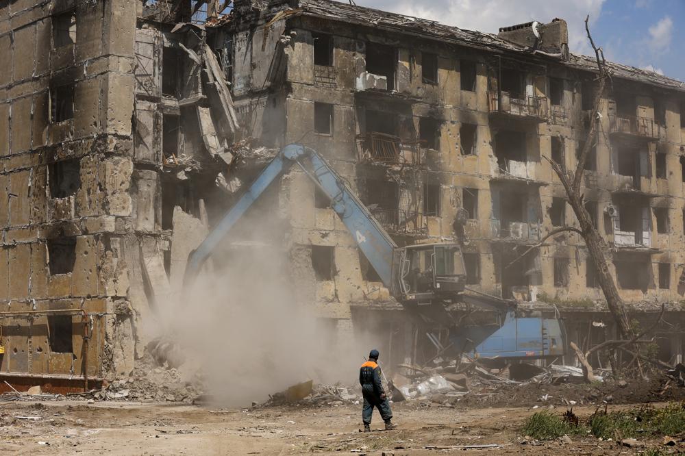 Russian Emergency Situations Ministry workers disassemble a destroyed building in Mariupol, in territory under the government of the Donetsk People's Republic, eastern Ukraine, Friday, May 27, 2022. (AP Photo/Alexei Alexandrov)