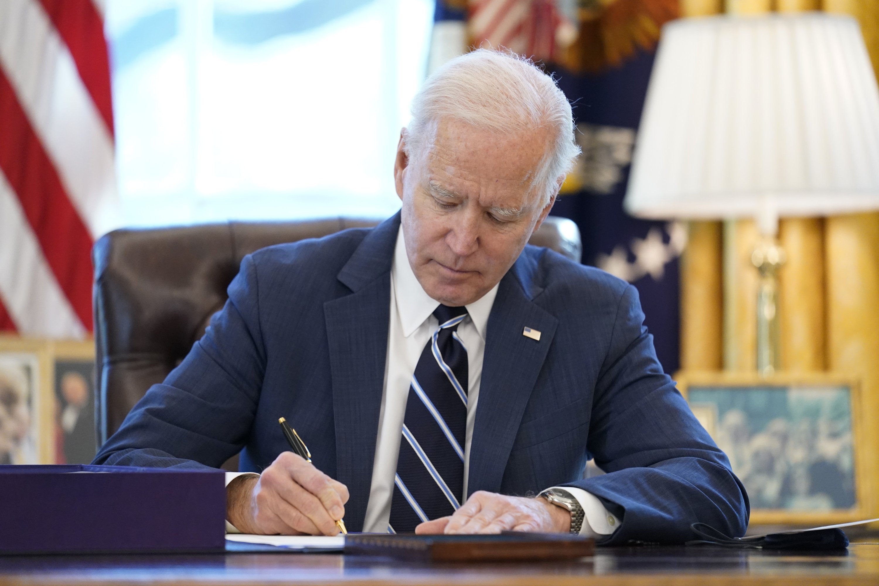 Biden signs major virus aid bill before addressing country