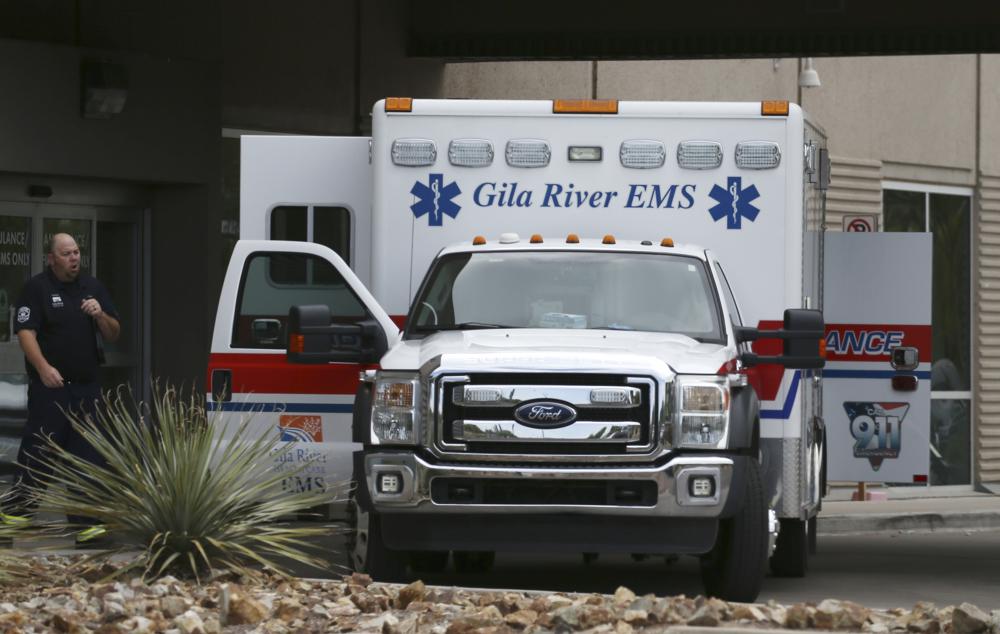 FILE - An ambulance parks at the emergency room entrance at Banner Estrella Medical Center July 19, 2020, in Phoenix. Officials say Phoenix-based Banner Health is at its most overwhelmed level since the pandemic began. That has led executives to issue a bleak warning that the hospital system may have to eventually choose who can receive care. (AP Photo/Ross D. Franklin, File)