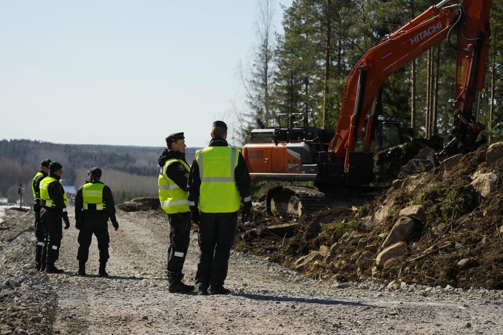 Finland's border guards stay at construction site of the border barrier fence between Finland and Russia near Pelkola border crossing point in Imatra, south-eastern Finland, Friday, April 14, 2023. (AP Photo/Sergei Grits)