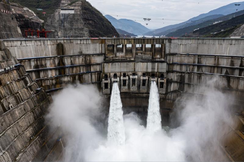 In this photo released by Xinhua News Agency, water is released from the dam of Baihetan hydropower station in Ningnan county, in southwestern China's Sichuan province on June 27, 2021. The Chinese government says it has turned on the first two generating units of the world's second-biggest hydroelectric dam. (Jiang Wenyao/Xinhua via AP)