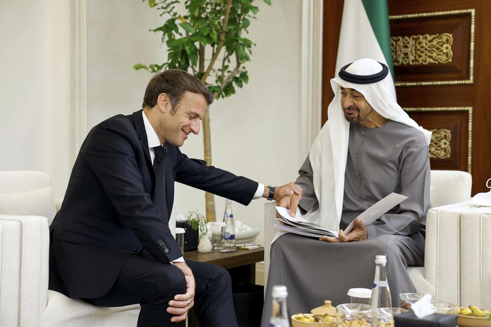 French President Emmanuel Macron, left, meets newly-elected president of the United Arab Emirates Sheikh Mohammed bin Zayed Al Nahyan to mourn the death of Sheikh Khalifa Bin Zayed Al Nahyan at Al Mushrif Palace in Abu Dhabi, United Arab Emirates, Sunday, May 15, 2022. (Christian Hartmann, Pool via AP)