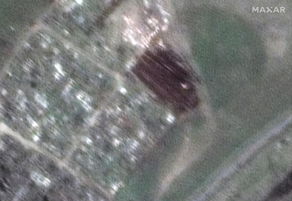 This satellite image provided by Maxar Technologies shows a closer view of new graves being dug at a cemetery near Vynohradne, approximately 12 kilometers east of Mariupol, Ukraine, on April 15, 2022. From mid-March through mid-April, there are new excavations at Vynohradne that consist of parallel trenches, with each trench approximately 40-meters long. (Satellite image ©2022 Maxar Technologies via AP)