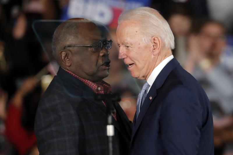 Then-Democratic presidential candidate Joe Biden talks to Rep. James Clyburn, D-S.C., at a primary night election rally in Columbia, S.C., Feb. 29, 2020 after winning the South Carolina primary. President Biden has frequently referenced the critical role South Carolina played in his nomination. He points to his decades-long relationship with the state whose Black voters handed him a major win at a desperate time for his Democratic campaign. But, in recent interviews with The Associated Press, some Black voters in South Carolina who supported Biden reluctantly — or not at all — say they’re unimpressed and even dispirited. (AP Photo/Gerald Herbert)